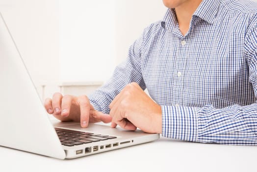 businessman s hand browsing laptop white table. Beautiful photo