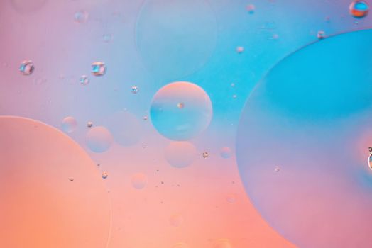 Oil drops in water. Defocused abstract psychedelic pattern image pastel colored. Abstract background with colorful gradient colors. DOF