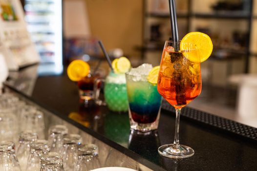 composition of various cocktails on the counter in strong colors and fruit on the head