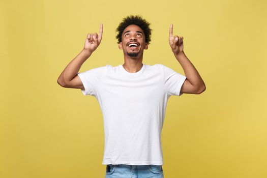 African american man with beard pointing away side with finger isolated over yellow background
