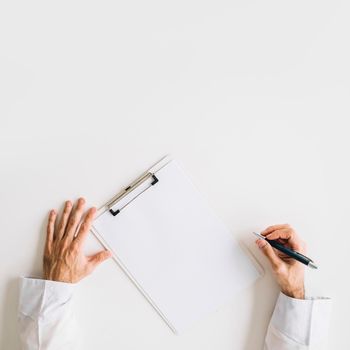 elevated view doctor s hand with blank white paper. Beautiful photo