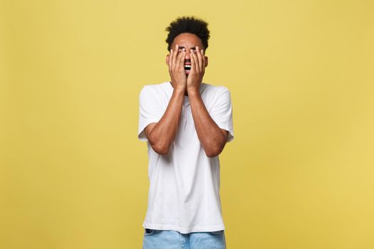 Closeup portrait man with sad expression, isolated on yellow wall background. Human emotions, body language, life perception. Duh moment