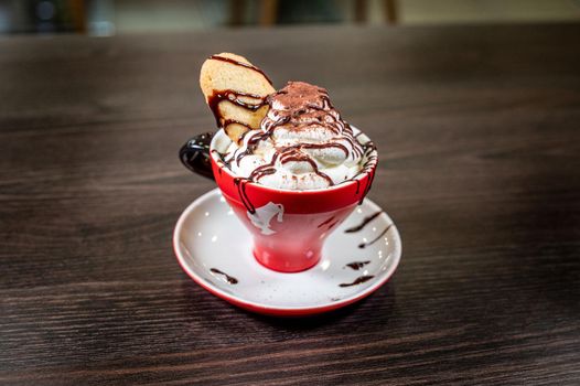 terni,italy october 08 2021:cup of chocolate and cream with biscuit