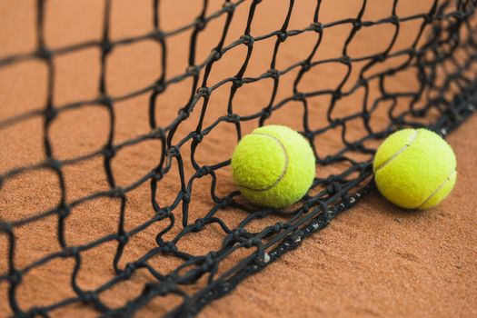 two tennis ball near black net ground. Resolution and high quality beautiful photo