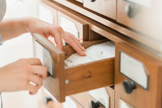 crop hands searching card drawer. Beautiful photo