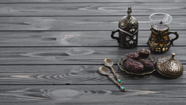 traditional turkish arabic tea glasses dried dates with spoons wooden table. Resolution and high quality beautiful photo