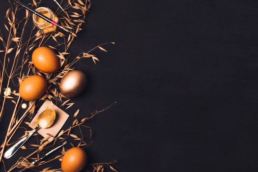 easter eggs near spoon paper brush dye can dry grass. High resolution photo