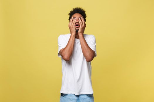 Closeup portrait man with sad expression, isolated on yellow wall background. Human emotions, body language, life perception. Duh moment