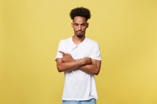 serious dark-skinned African American young man shows a finger upwards.