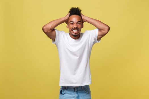 Portrait of angry or annoyed young African American man in white shirt looking at the camera with displeased expression. Negative human expressions, emotions, feelings. Body language