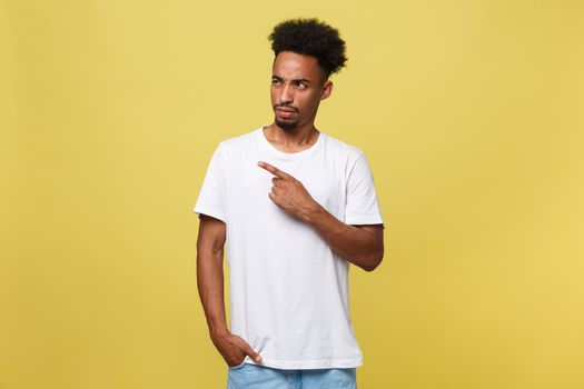 Young handsome african american man over yellow background pointing upwards