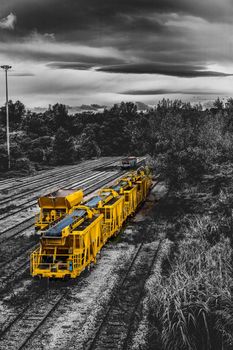 landscape with yellow freight train stationary