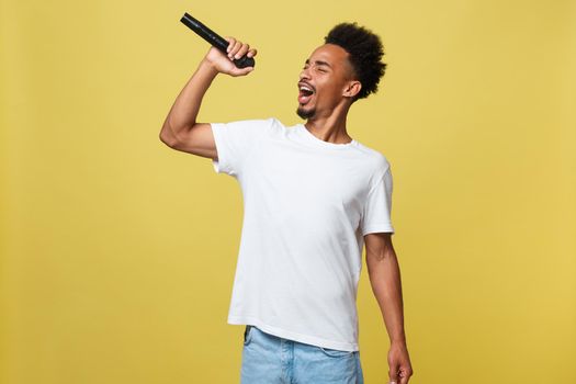 young handsome african american boy singing opera emotional with microphone