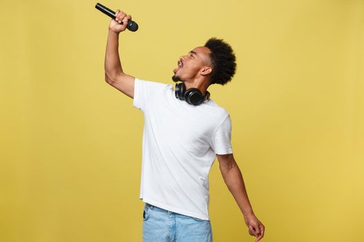 young handsome african american boy singing opera emotional with microphone