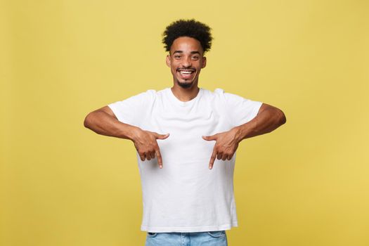 Young african american man pointing to camera with fingers isolated on yellow background.