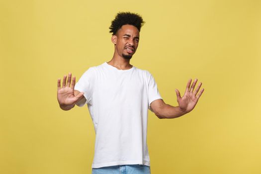 Portrait furious angry annoyed displeased young man raising hands up to say no stop right there isolated orange background. Negative human emotion, facial expression, sign, symbol, body language