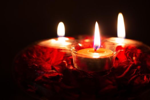 red candles in a candlestick on a black background, close-up