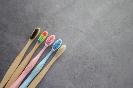 colorful toothbrushes on a black background with copy space ,