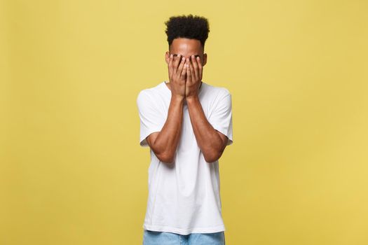 Closeup portrait man with sad expression, isolated on yellow wall background. Human emotions, body language, life perception. Duh moment