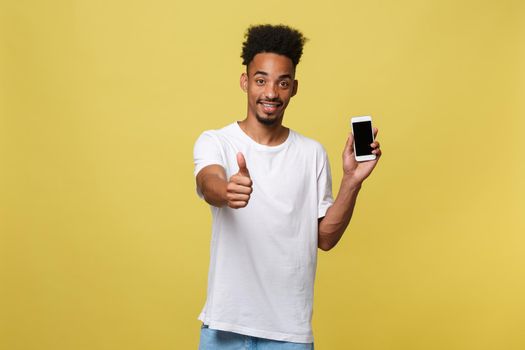 Portrait of cheerful african american man talking on cellphone with thumbs up hand sign.