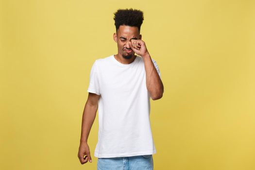 Closeup portrait man with sad expression, isolated on yellow wall background. Human emotions, body language, life perception. Duh moment