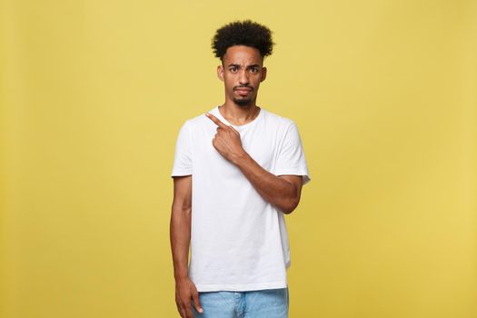 serious dark-skinned African American young man shows a finger upwards.