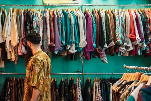 young man shirt choosing clothes mall clothing store. Beautiful photo