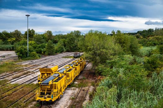 landscape with yellow freight train stationary