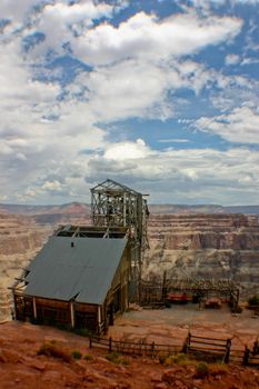 Image of Abandoned shell of a building is surrounded by a large canyon on a cloudy day