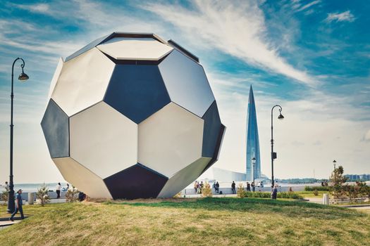 A huge ball against the background of the Lakhta Center near the Zenit stadium. Close up