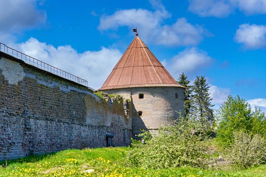 View of the old stone fortress with a watchtower. Fortress Oreshek on a sunny summer day