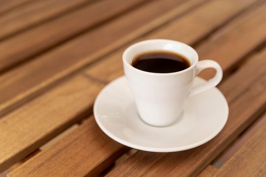 tasty cup black coffee wooden table. High resolution photo