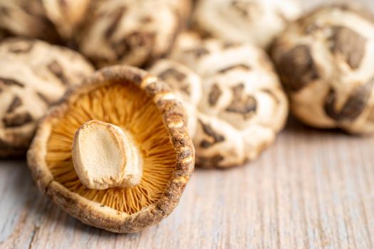 Dried shiitake mushroom on wooden background. Healthy food.