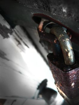 Image of Close-up shot of a rusty lock attached to an iron door