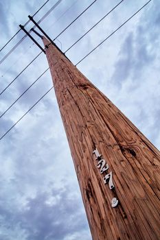 Image of Telephone pole communications with dark clouds