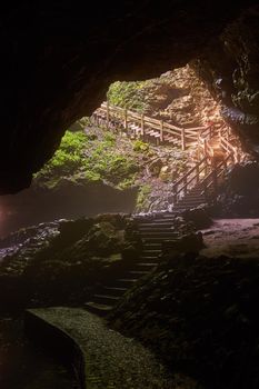 Image of Large cave opening with stairs leading outside