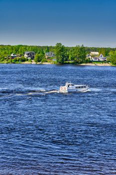 The river boat transports people to the other side. River crossing by water