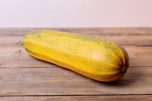 Yellow ripe zucchini on wooden boards. Autumn concept. Close-up.