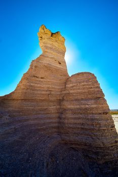 Image of Sun blocked by large pillars of rock in desert