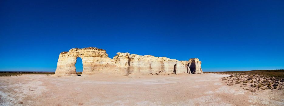 Image of Panorama of large wavy white rocks in middle of flat desert