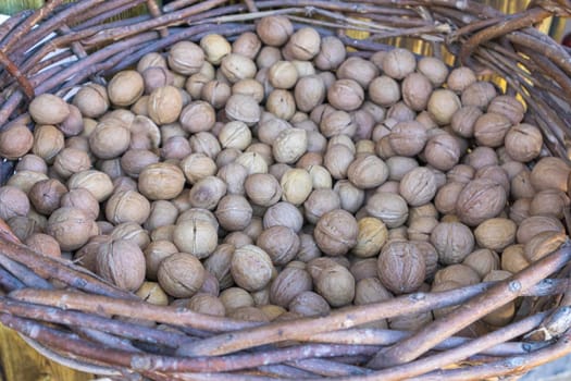 walnuts in a large wicker basket close-up. High quality photo