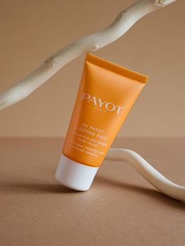 Moscow, Russia, 08.30.2021 Skin moisturizer cosmetic care night mask Payot with orange package on shiny beige background.