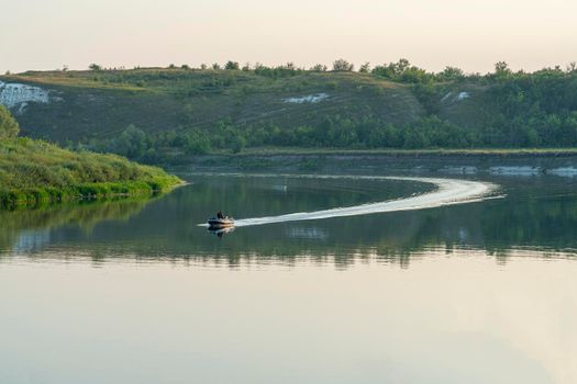 a rubber motor boat floats on a large river. High quality photo