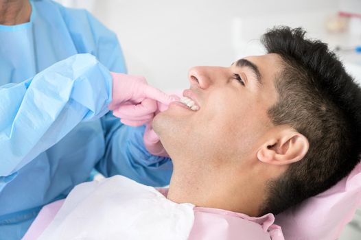 Doctor treats patient teeth in modern dental clinic. High quality photo