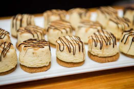 Gourmet dessert pastries with vanilla filling and chocolate icing. Close up