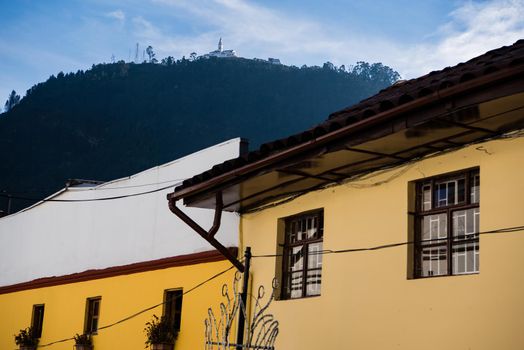 Mount Monserrate Colombia with yellow buildings in the foreground creating geometric shapes