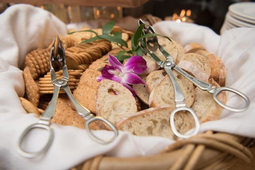Pretty bread and cracker basket with serving tongs