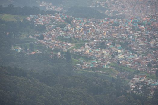View of many pastel homes from the top of Mount Montserrate in Bogota Colombia.