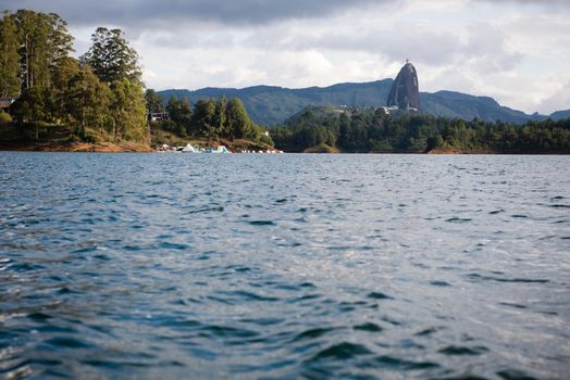 View of El Penon de Guatape in the distance from the water.