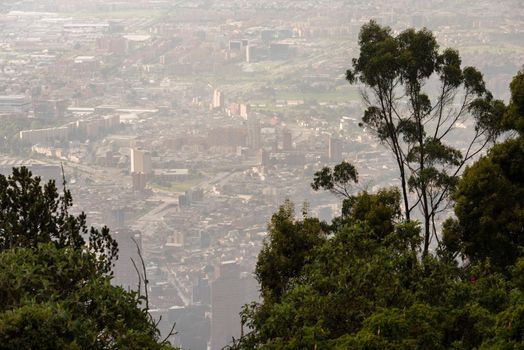 View through trees from the top of Mount Montserrate in Bogota Colombia.